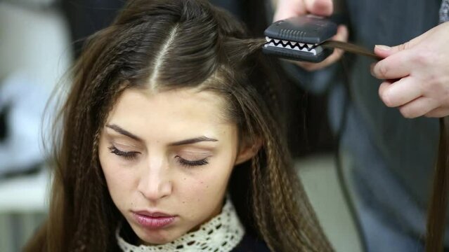 Face of girl model whose hair makeup artist goffers.