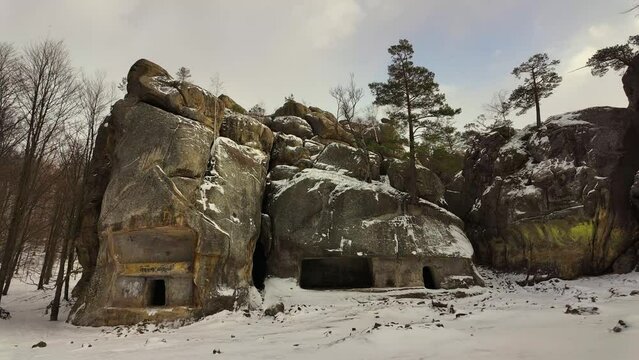 ancient cave monastery in the Carpathians in Bubnyshche, Ukraine, which is hundreds of years old, and the Dovbush rocks are millions of years old. Time lapse with clouds that symbolize transience