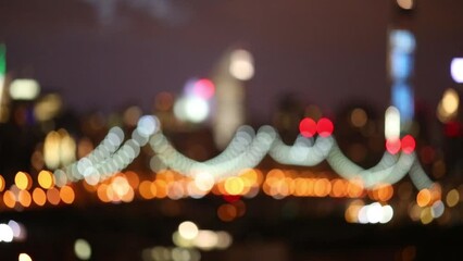 Illuminated suspension bridge in modern city out of focus at night - Powered by Adobe