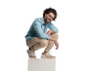 casual man leaning forward while standing on crate - Powered by Adobe