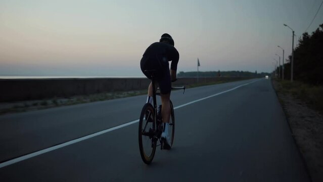 Strong Triathlete cyclist training on bicycle	