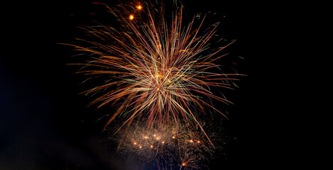 Colorful celebration fireworks isolated on a black sky background.Abstract and brightly firework in the celebration and anniversary festival.Merry Christmas and New year party light on night sky.