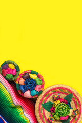 Mexican handicrafts and serape on yellow background. Mexican independence concept. Cinco de mayo background.