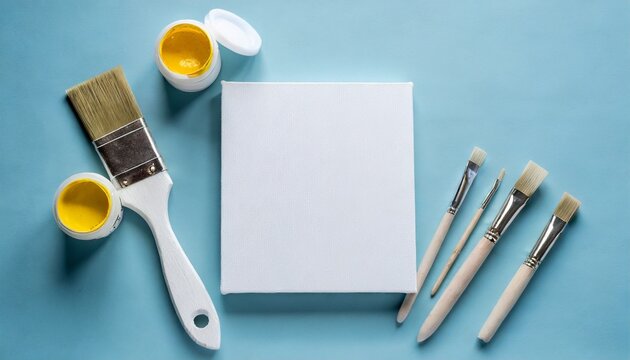 blank canvas tubes of oil paints and spatula on light blue background flat lay space for text