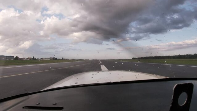 Student pilot taking off from Lennart Meri Tallinn International Airport runway 08 during a rainy day.