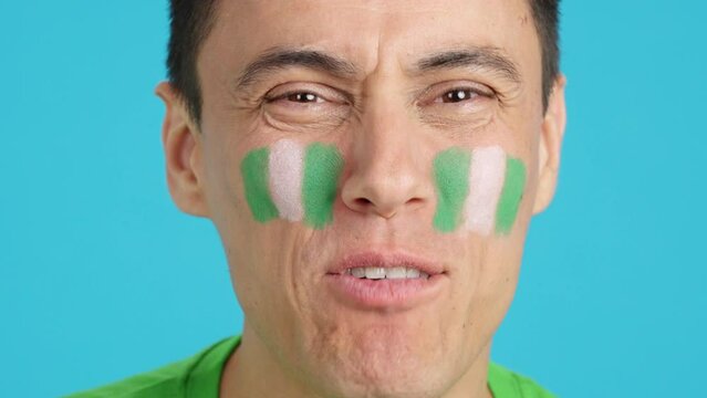 Close up of a man supporting nigerian team