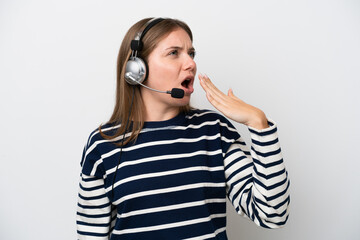 Telemarketer caucasian woman working with a headset isolated on white background yawning and covering wide open mouth with hand