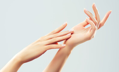 Hand skin care. Closeup of beautiful woman hands with  light manicure on nails . Cream for hands...