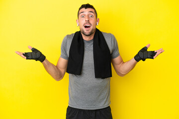 Young sport caucasian man isolated on yellow background with shocked facial expression