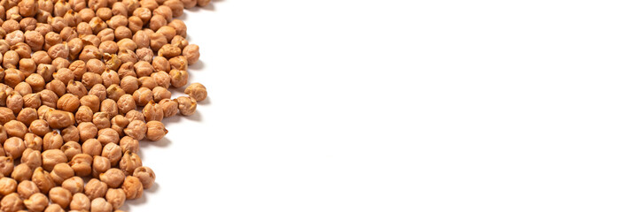 Dry organic chickpeas in a wooden spoon isolated on white background with copy space. Banner. Top view. 