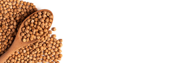 Dry organic chickpeas in a wooden spoon isolated on white background with copy space. Banner. Top view. 