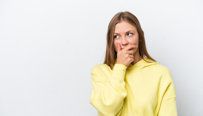 Young Russian woman isolated on white background having doubts and with confuse face expression