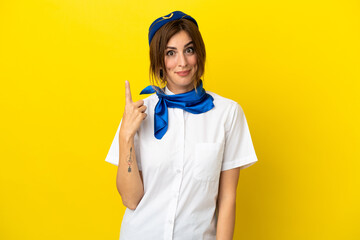 Airplane stewardess woman isolated on yellow background pointing with the index finger a great idea