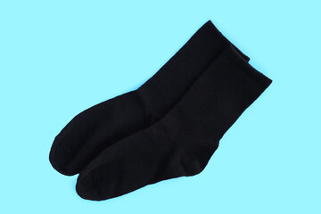 Black socks on blue background.
