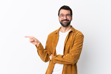 Caucasian handsome man with beard wearing a corduroy jacket over isolated white background pointing...
