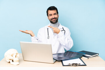 Professional traumatologist in workplace holding copyspace imaginary on the palm to insert an ad