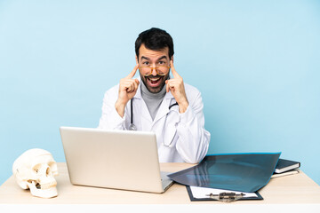 Professional traumatologist in workplace with glasses and surprised