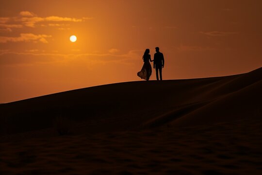 Silhouette of a Couple in Desert at Sunset