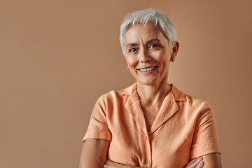 Woman's beauty and maturity. Portrait of a beautiful gray-haired woman with a short hairstyle on a...
