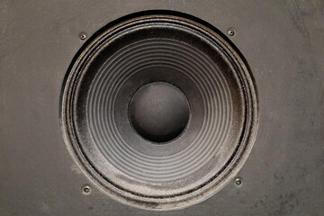 Closeup photo of a speaker. Used studio audio speaker. Music, grunge background.