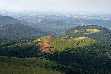 Auvergne vulcan since top of the Puy de Dome vulcan at sunset. Dramatic light landscape. Clermont Ferrand, France.