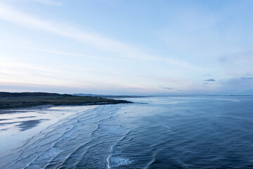 Stunning aerial drone landscape image of Northumberland beach in Northern England during Winter sunrise