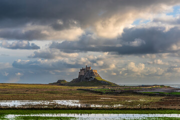 Stunning dramatic landscape image of Lindisfarne, Holy Island in Northumberland England during...