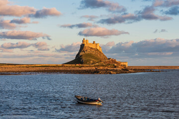 Stunning dramatic landscape image of Lindisfarne, Holy Island in Northumberland England during Winter