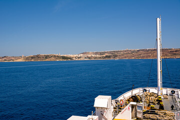 Mgarr and its port on the island of Gozo (Malta) and bow of the carferry - 714663486