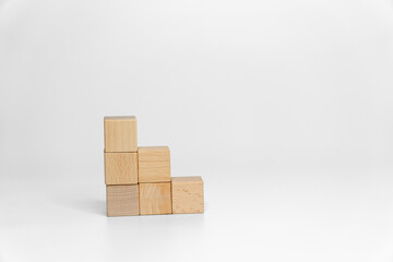 building wood blocks on white background; business or creative concept