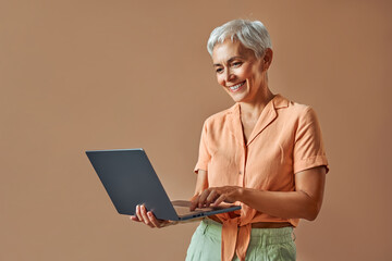 Smiling happy sincere confident mature beautiful gray haired stylish modern creative woman dressed...