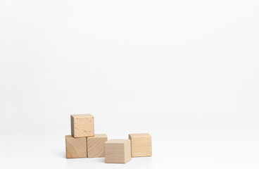 building wood blocks on white background; business or creative concept