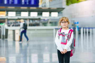 Little Tired Preschool Girl at Airport Terminal. Cute Sad Child After Long Flight with Airplane.