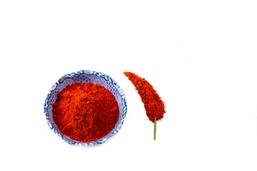 Grated paprika in a ceramic bowl on a white background. - 714669089