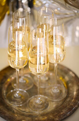 Close up of shiny glasses of champagne over party background