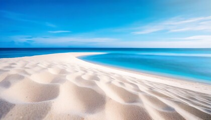 Fototapeta na wymiar white sand curve or tropical sandy beach with blurry blue ocean and blue sky background image for nature background or summer background