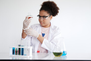 Smiling African black girl student is study and test for chemical and science. She is experimenting...