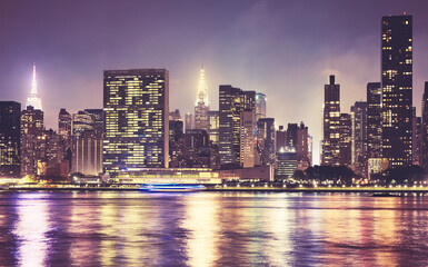 Fototapeta na wymiar Manhattan waterfront skyline at night, color toning applied, New York City, USA.