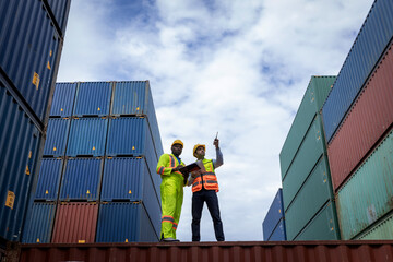 Foreman or worker work at Container cargo site check up goods in container. Foreman or worker...