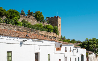 Torreón y muralla almenada del alcázar templario sobre las casas blancas de la villa de Jerez de...