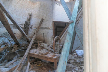 View of the interior of a house that is destroyed and abandoned from the outdoor window