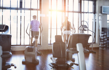Couple training on a treadmill in a sport centre