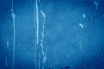 Blue cement surface with streaks of paint texture background