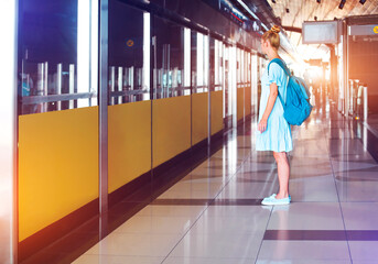 Happy young woman traveling in metro