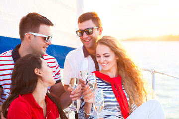 Smiling friends sitting on yacht deck