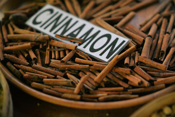 cinnamon sticks on a wooden plate closeup