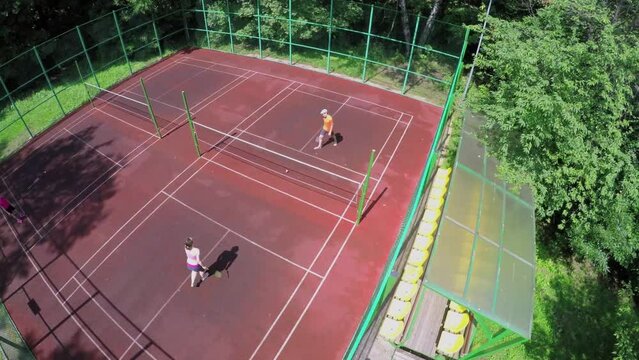 Mother and her son plays badminton at summer sunny day