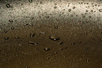 Fototapeta na wymiar drops of rain on a black glass