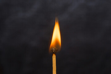 burning candle with smoke isolated on black background.