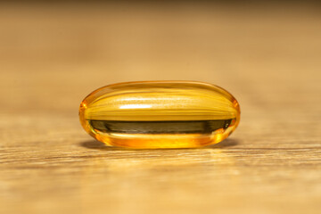 close - up of omega 3 gel capsules in a transparent glass jar